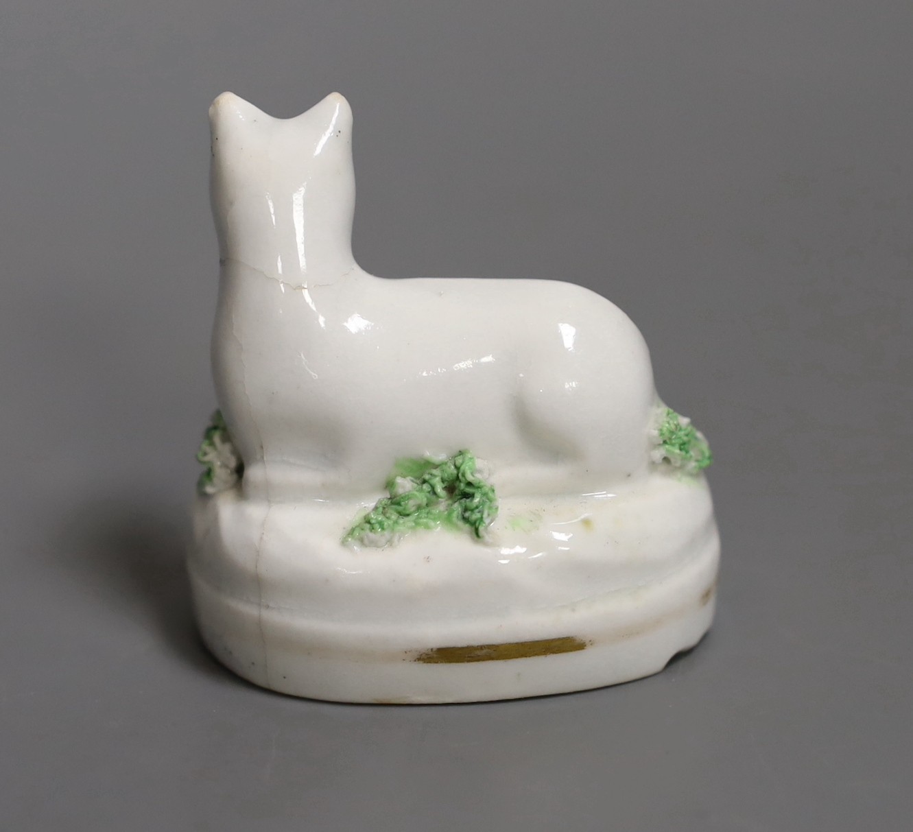 A rare Staffordshire porcelain figure of a recumbent cat, c.1830-50, 4.7cm, Not recorded in Dennis G.Rice, Cats in English porcelain., Provenance: Dennis G.Rice collection